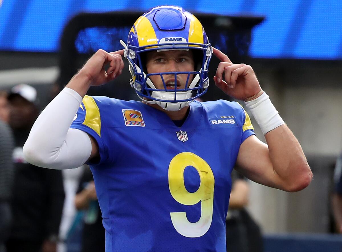 Rams quarterback Matthew Stafford points to his helmet and signals to the offense during a win over the Panthers 