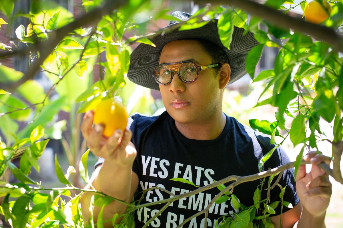 Plywright Roger Q. Mason poses with backyard citrus in Los Angeles