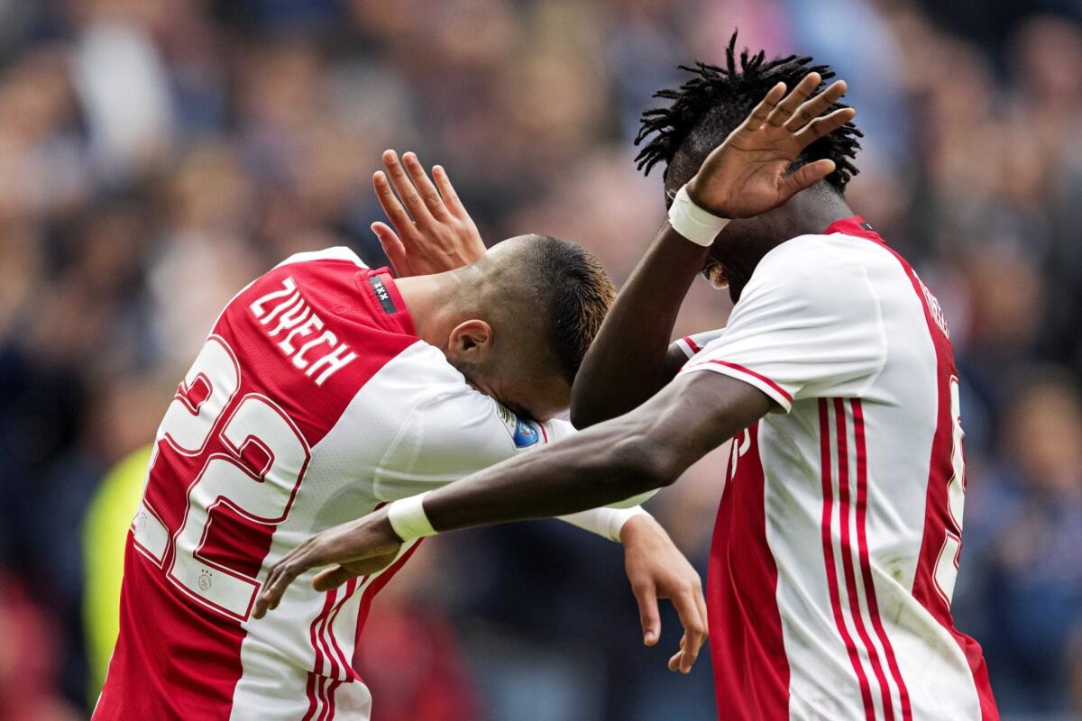 Hakim Ziyech, left, celebrates by dabbing with Ajax teammate Bertrand Traore after scoring against FC Utrecht in Amsterdam on Oct 2, 2016.
