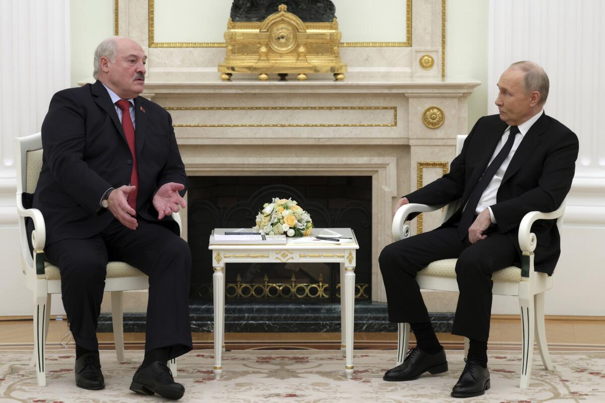 Russian President Vladimir Putin sits with Belarus President Alexander Lukashenko.