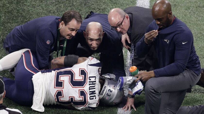 New England's Patrick Chung is helped by medical staff after an injury during the second half of the Super Bowl.