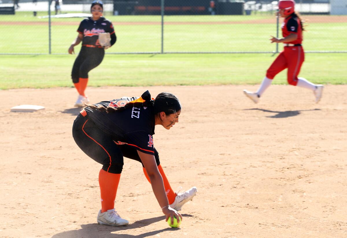 Los Amigos' Yvonne Gonzalez (9) fields the ball at third base against A.B. Miller on Tuesday.