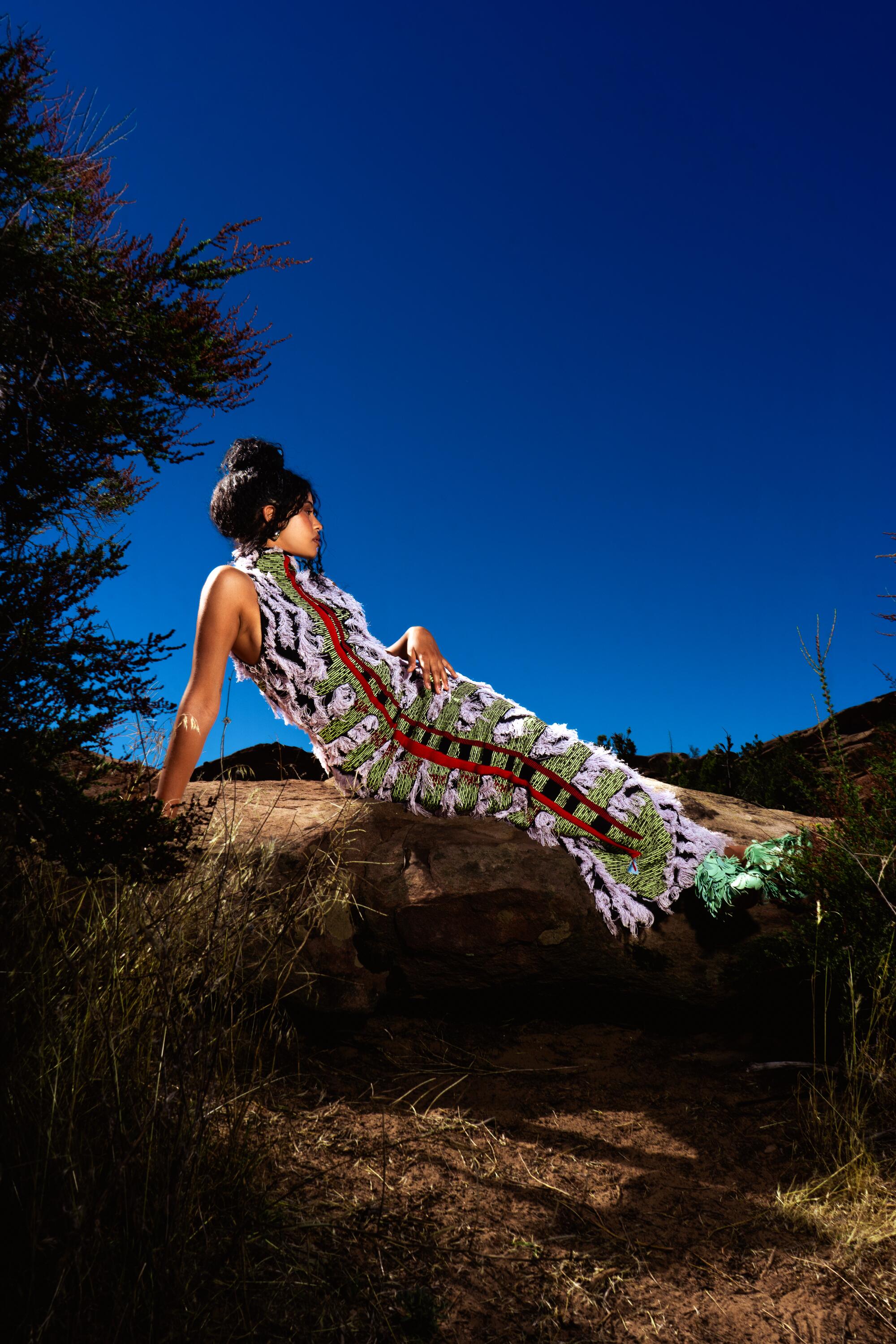 Artist Yendry poses in the desert.