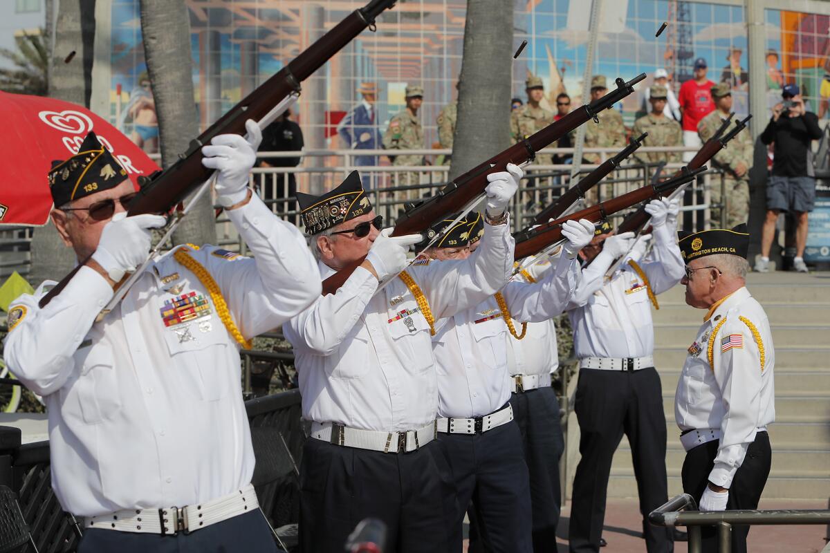 American Legion honor guard perform a three volley rifle salute.