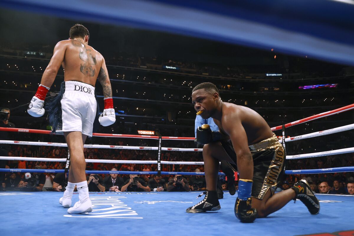 Javier Fortuna kneels on the canvas after being knocked down by Ryan Garcia.