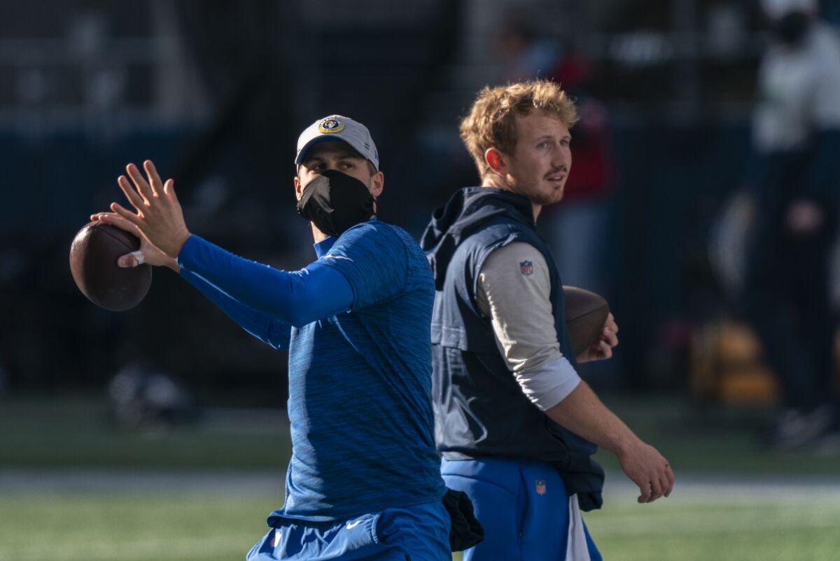 Rams quarterbacks Jared Goff, left, and John Wolford take part in throwing drills.