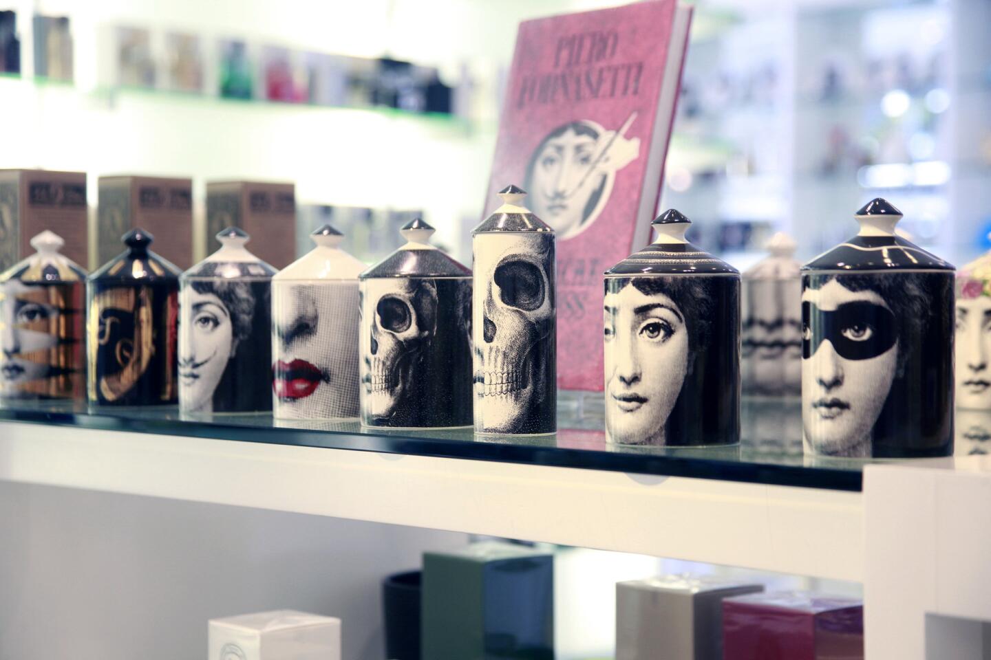 Fornasetti's L'eclaireuse lidded candles