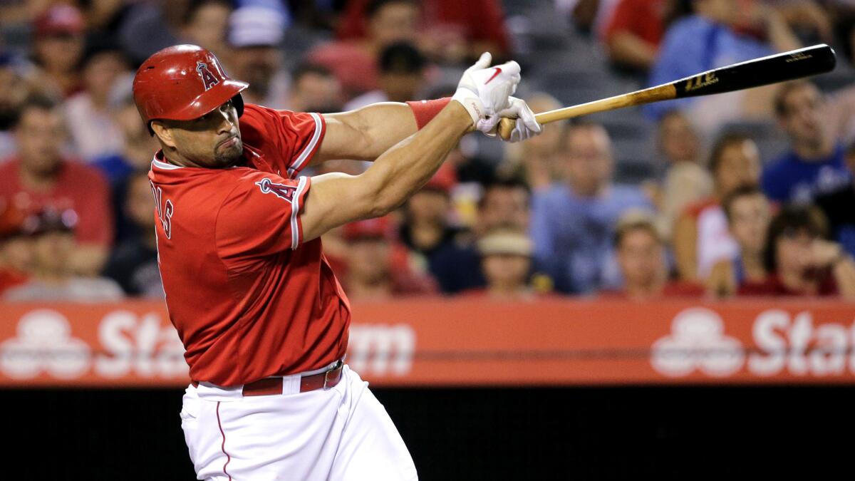 Angels designated hitter Albert Pujols delivers what proved to be the game-winning hit with a run-scoring single in the eighth inning against the Dodgers on Wednesday night in Anaheim.