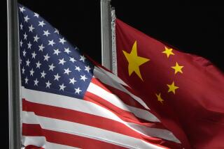 FILE - The American and Chinese flags wave at Genting Snow Park, Feb. 2, 2022, in Zhangjiakou, China. (AP Photo/Kiichiro Sato, File)