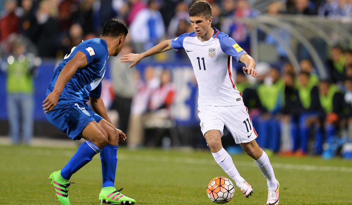 United States' Christian Pulisic maneuvers with the ball against Guatemala's Carlos Castrillo in the second half during the FIFA 2018 World Cup qualifier on March 29.