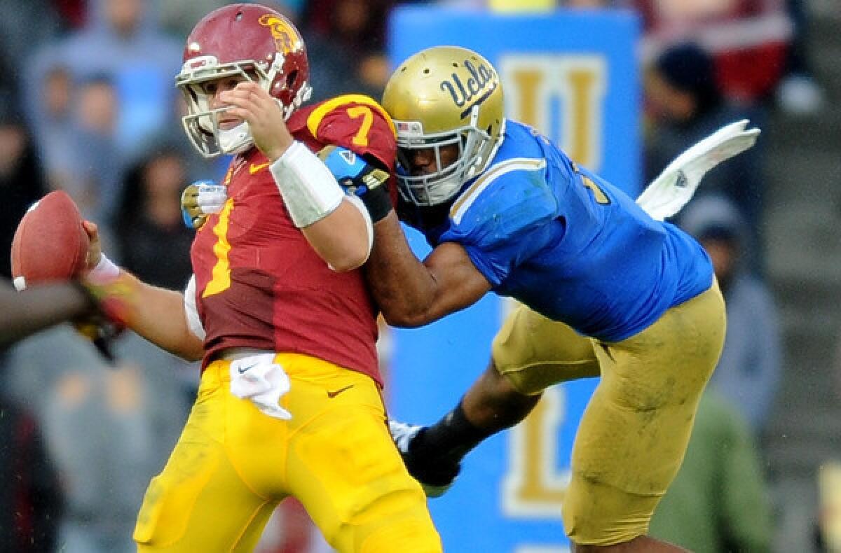 UCLA linebacker Anthony Barr sacks USC quarterback Matt Barkley in the fouth quarter Saturday at the Rose Bowl.