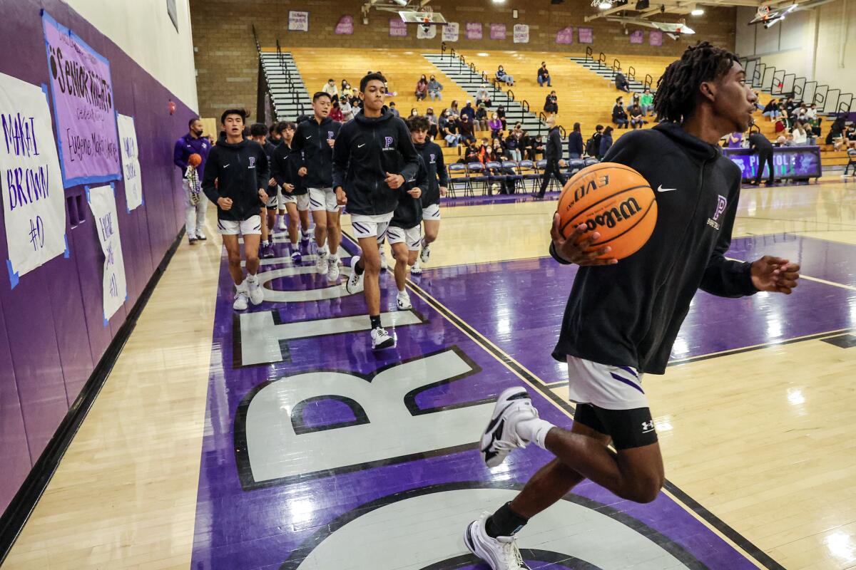 Makai Brown warms up with teammates.