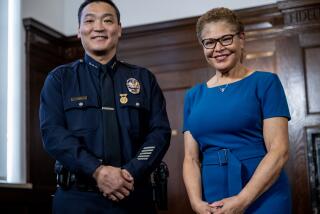 LOS ANGELES, CA - FEBRUARY 7, 2024: New LAPD interim Chief Dominic H. Choi stands with with Mayor Karen Bass after being named to the position at City Hall on February 7, 2024 in Los Angeles, California. (Gina Ferazzi / Los Angeles Times)