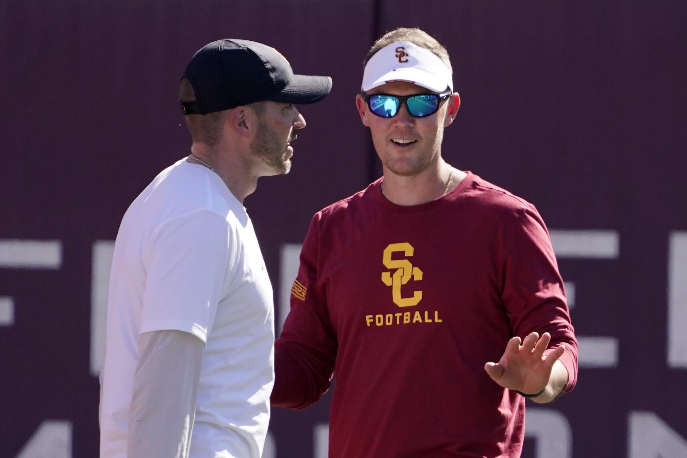 USC coach Lincoln Riley, right, talks with defensive coordinator Alex Grinch during a practice.