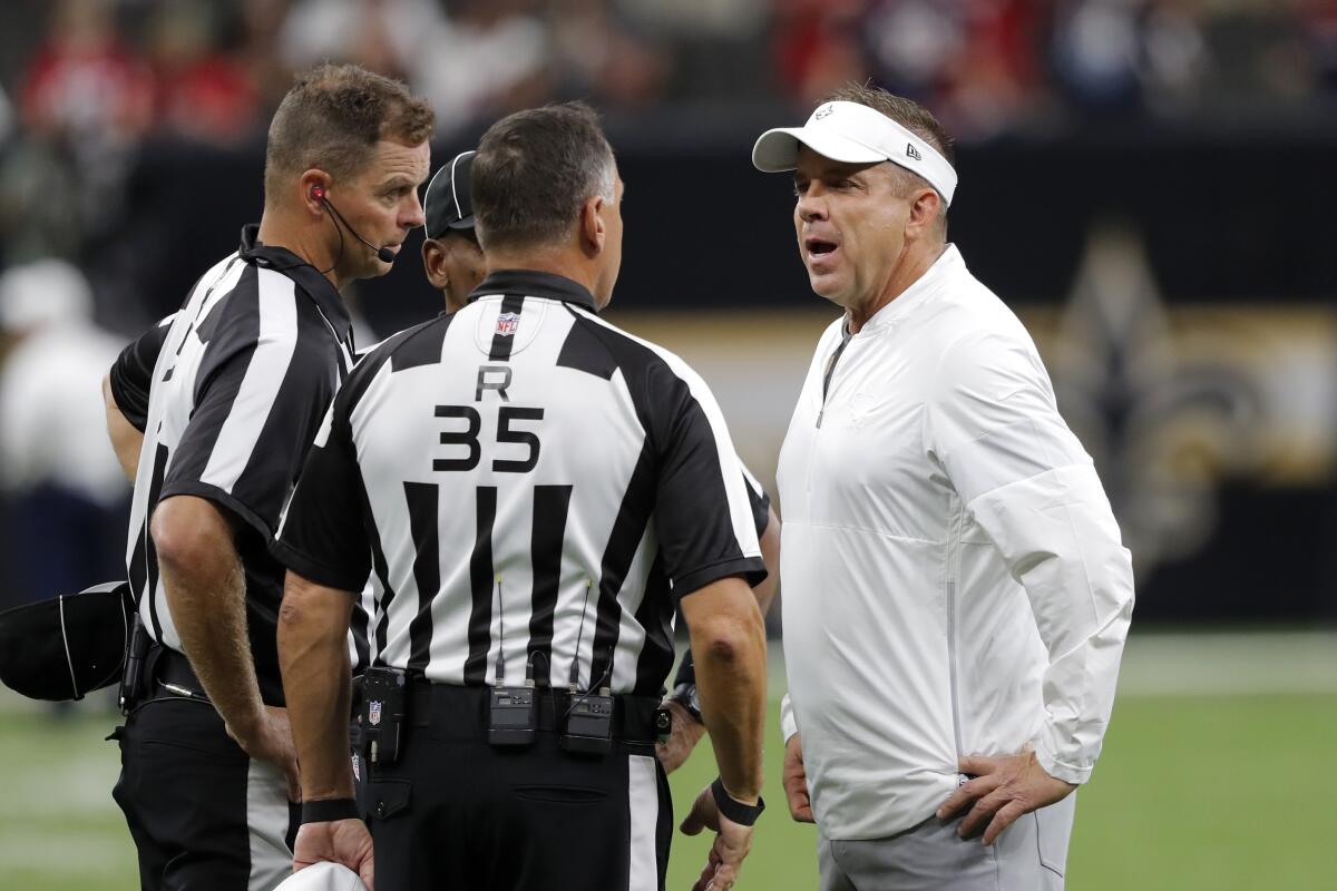 Saints coach Sean Payton talks to NFL referees before a game against the Houston Texans on Sept. 9.