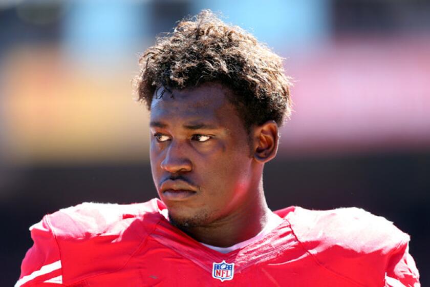 Aldon Smith watches from the sideline during the 49ers' season-opening game against the Green Bay Packers at Candlestick Park.