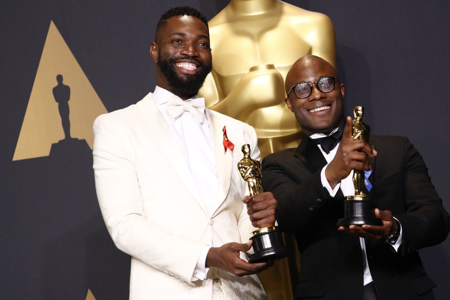 Tarell Alvin McCraney, left, and Barry Jenkins won the Oscar for adapted screenplay for "Moonlight."