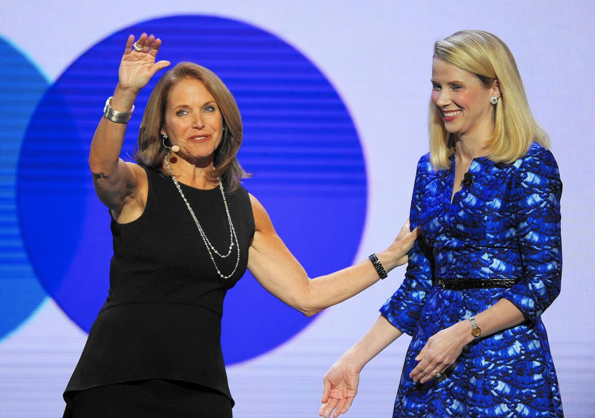 Hiring Katie Couric was part of a larger push by Yahoo CEO Marissa Mayer to expand into original content. Above, Couric, left, on stage with Mayer at the International CES in 2014.