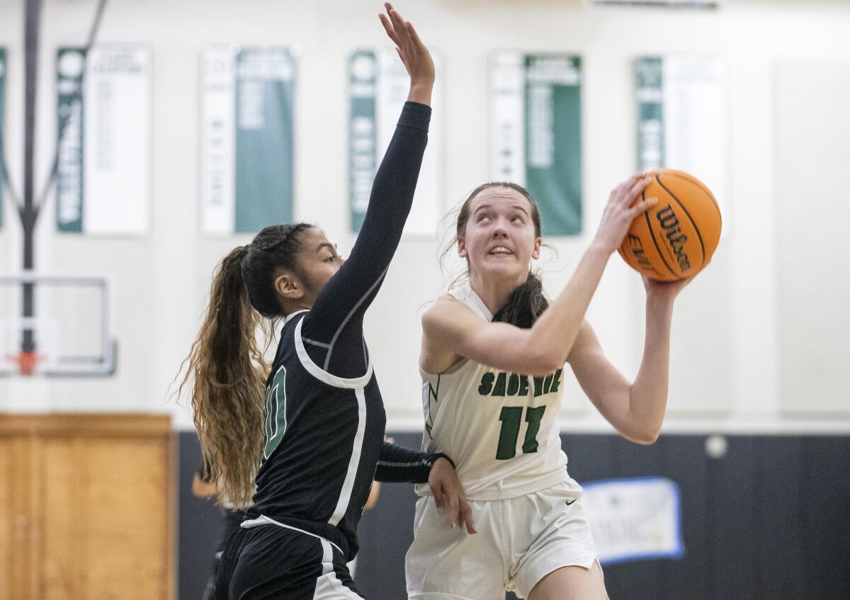 Sage Hill's Kat Righeimer goes up for a shot against Fairmont Prep's Madeleine Salud in a San Joaquin League game on Jan. 20.