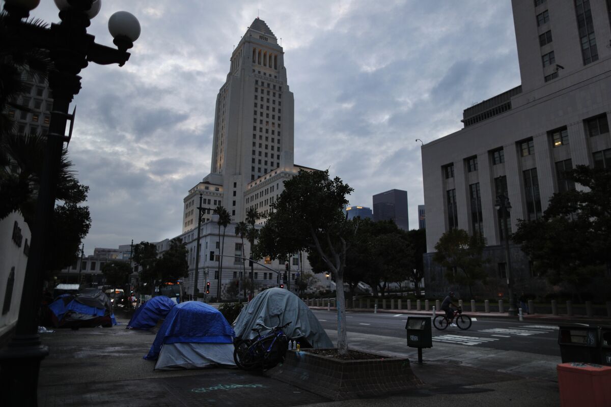  A small homeless encampment sits in the shadow of L.A. City Hall on Jan. 17. 