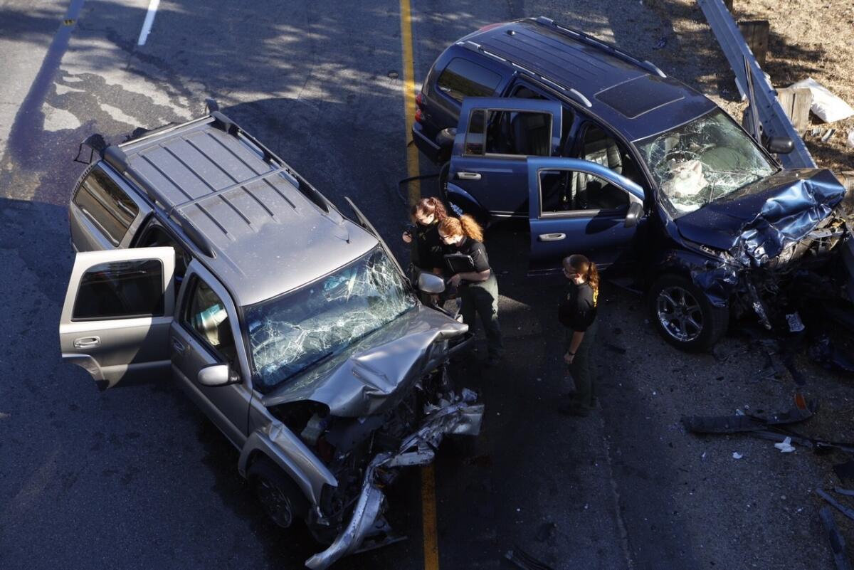 A San Bernardino County sheriff's deputy in a helicopter shot and fatally wounded a man driving a Chevy Tahoe the wrong way during a chase on the 215 Freeway in San Bernardino on Sept. 18, 2015, but the vehicle kept going and crashed head-on into a family in a Dodge Durango, right.