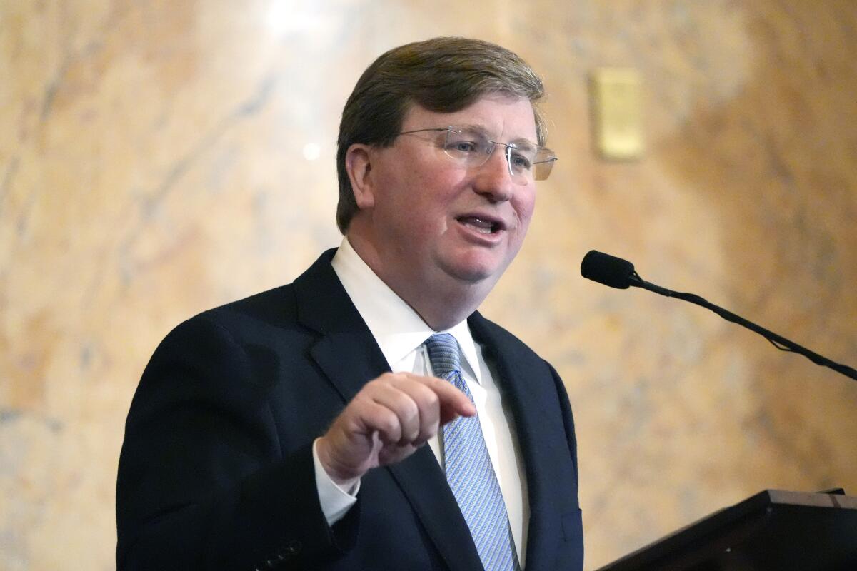 Mississippi Gov. Tate Reeves at a microphone.