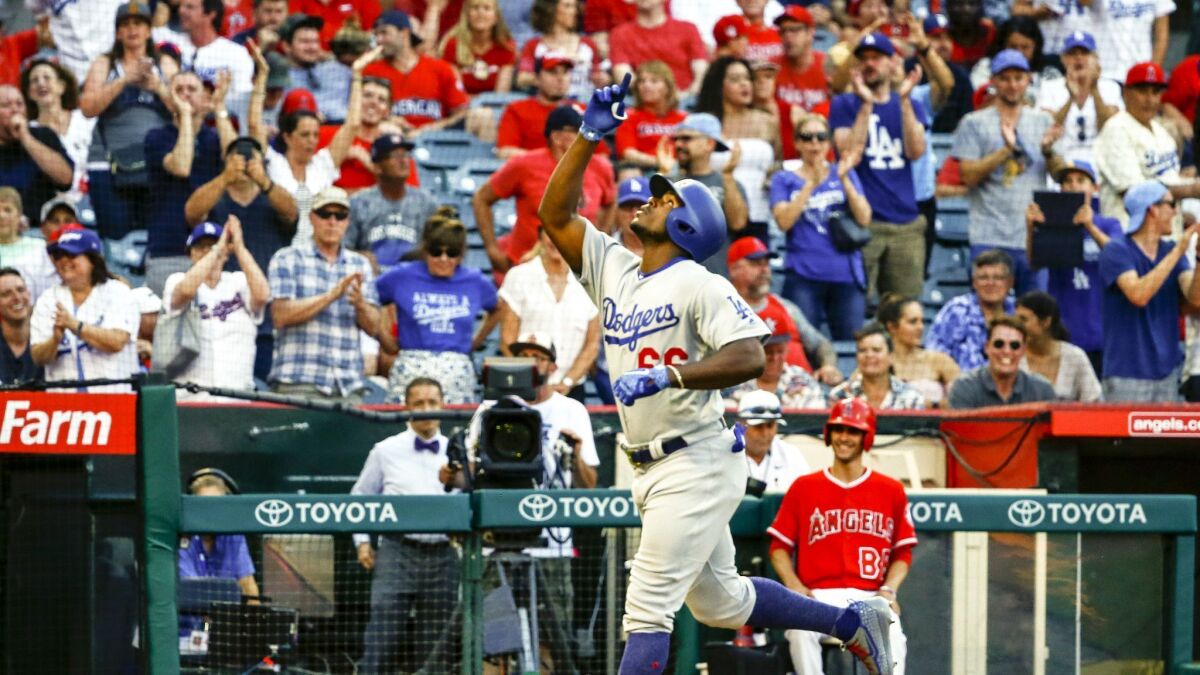 Los Angeles Dodgers right fielder Yasiel Puig (66) celebrates a home run in the ninth inning against the Angels.