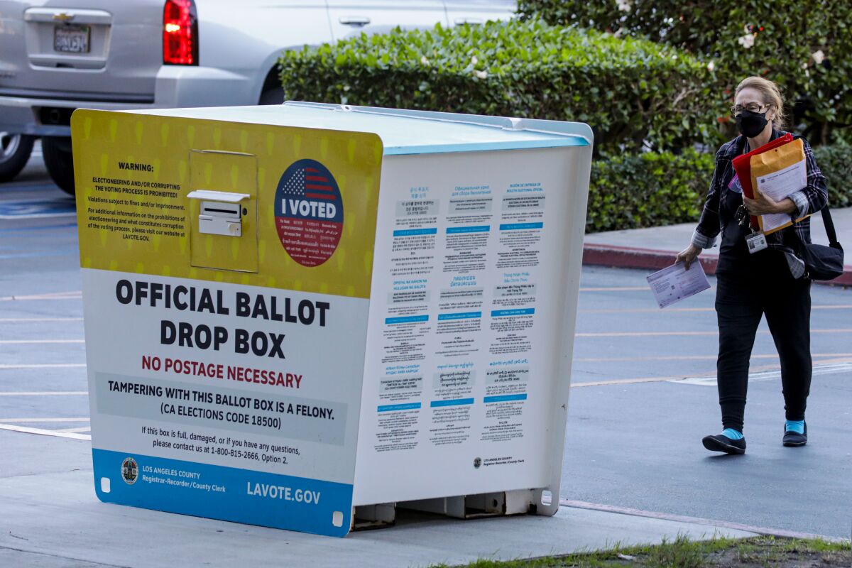 A woman with her ballot at the Los Angeles County Registrar-Recorder/County Clerk headquarters drop box in Norwalk.