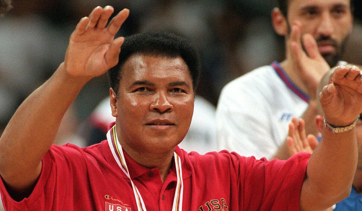 Muhammad Ali acknowledges fans at the gold medal basketball game between the U.S. and Yugoslavia at the Atlanta Olympic Games on Aug. 3, 1996.