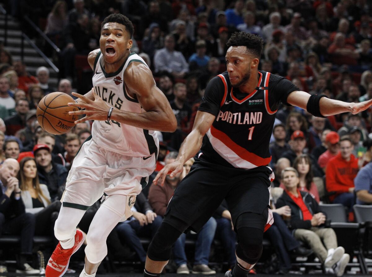 Bucks forward Giannis Antetokounmpo drives to the basket against Trail Blazers guard Evan Turner during the second half of their game Nov. 6.