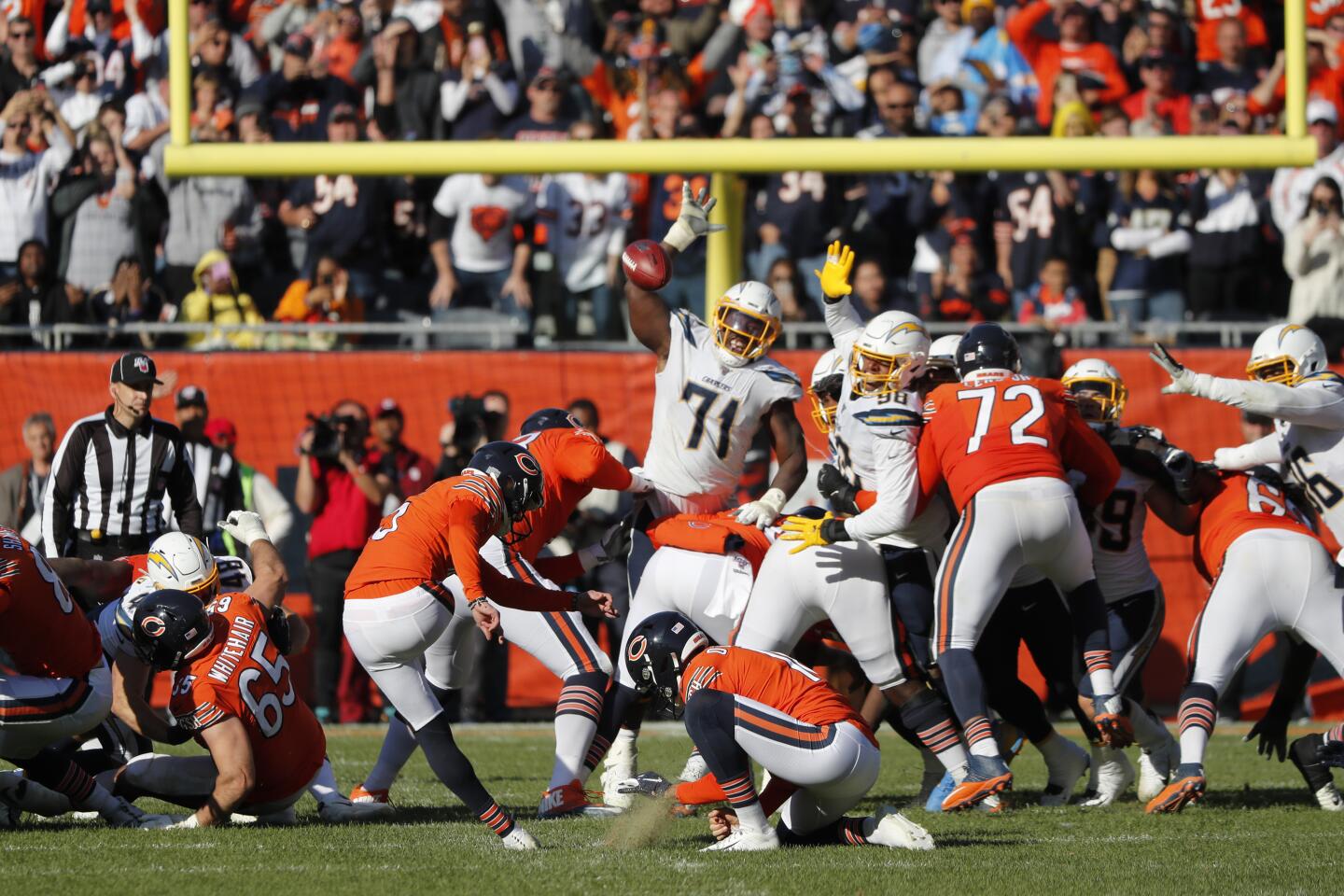 Chicago Bears kicker Eddy Pineiro, left, attempts a field goal on the final play of an NFL football game against the Los Angeles Chargers, Sunday, Oct. 27, 2019, in Chicago. Pineiro missed the field goal as the Chargers won 17-16. (AP Photo/Charles Rex Arbogast)