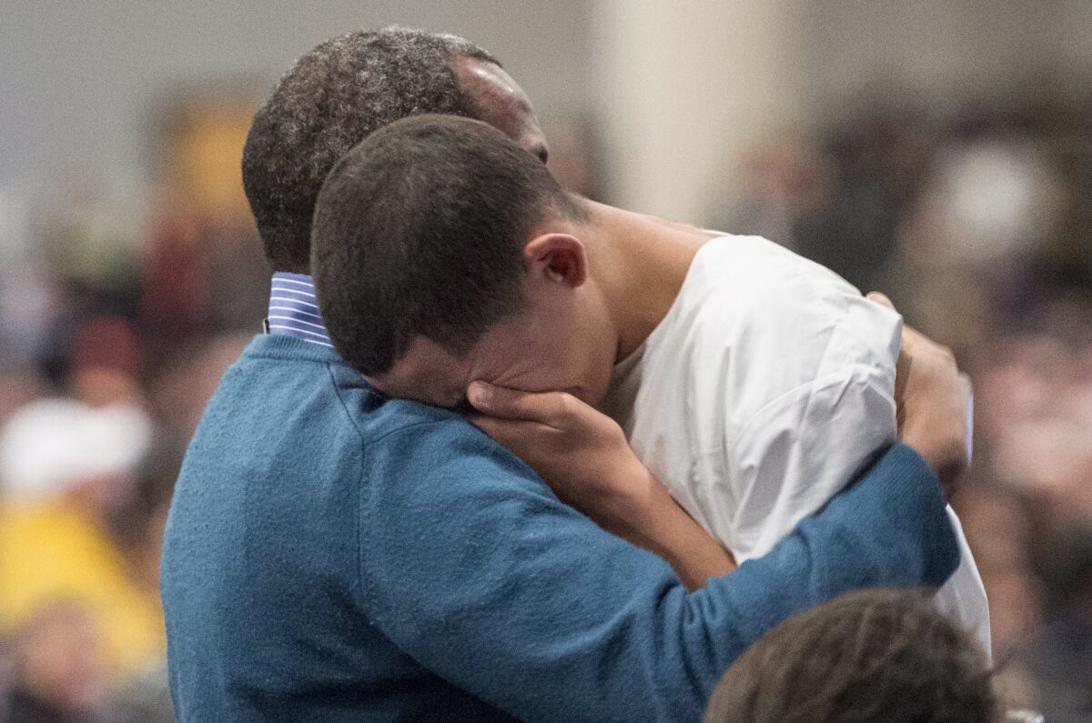 Ilies Soufiane, 15-year-old son of victim Azzeddine Soufiane, is consoled during a ceremony Friday for three of the six victims of the Quebec City mosque shooting.