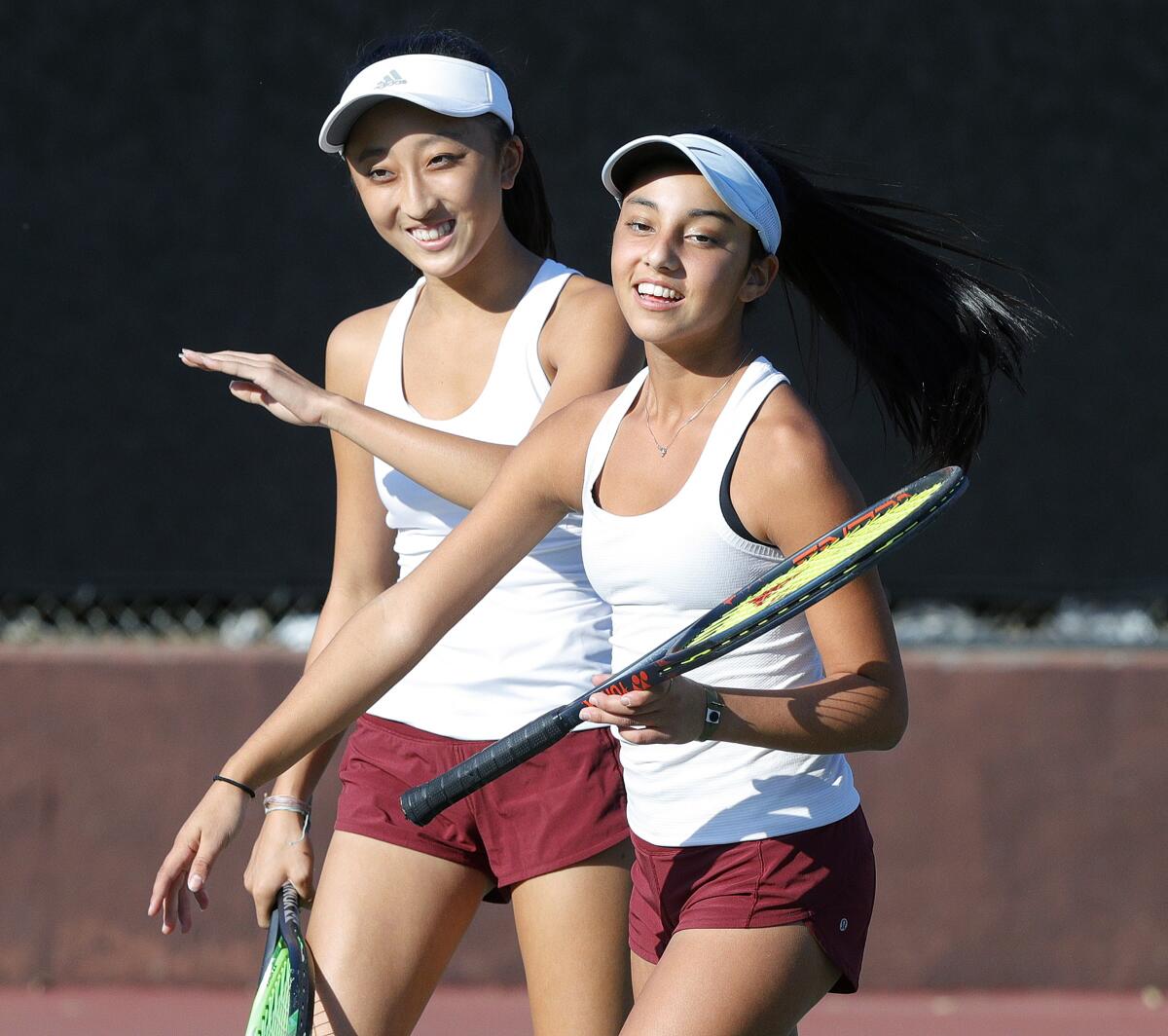 La Canada's Maya Urata and Eliana Hanna congratulate each other after winning a point in a Rio Condo League girls' tennis match against South Pasadena at La Canada High School on Monday, October 28, 2019.