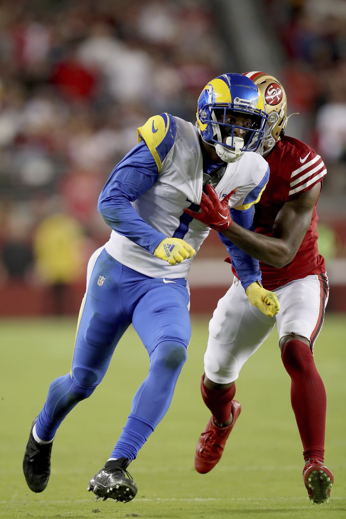 Rams receiver Allen Robinson II tackles 49ers cornerback Charvarius Ward while running a pass route.