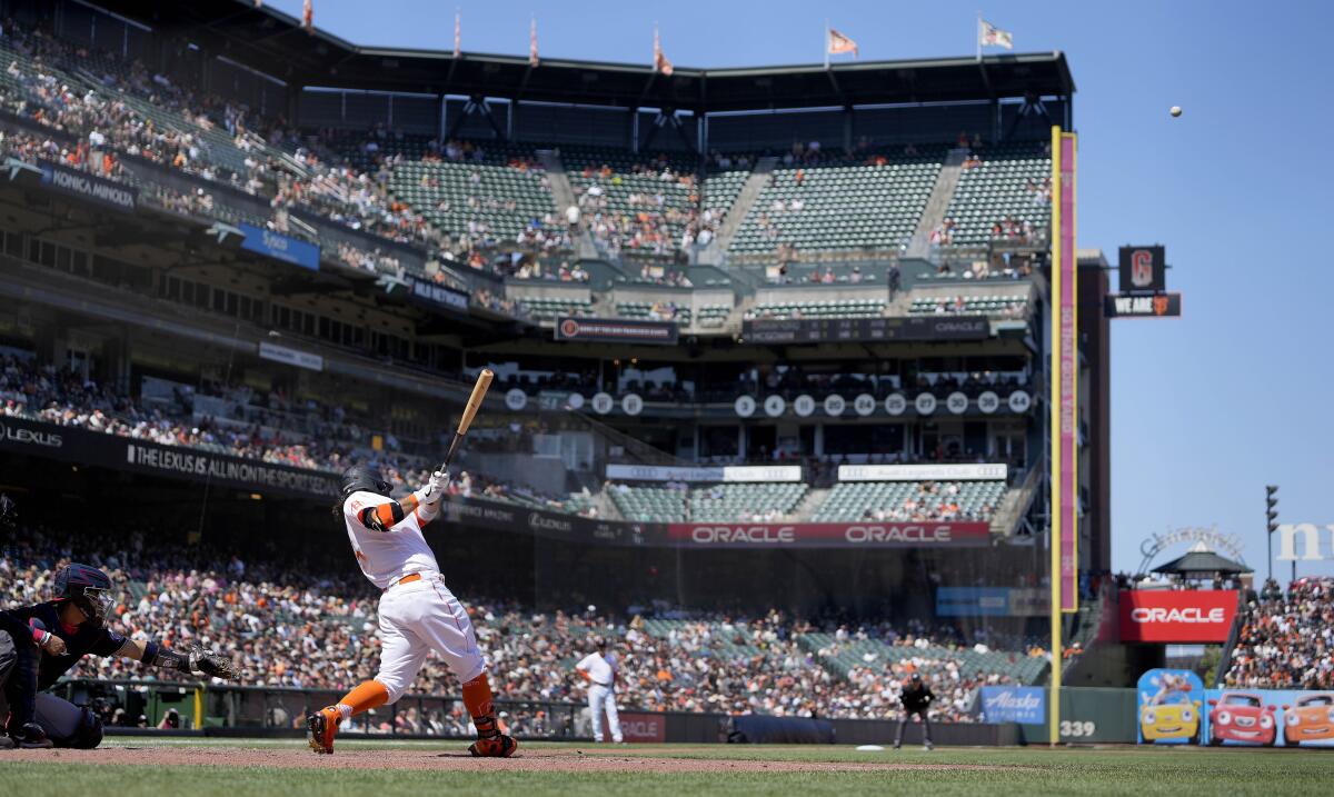 San Francisco Giants' Brandon Crawford, second from left, hits a solo home run against the Washington Nationals during the sixth inning of a baseball game Saturday, July 10, 2021, in San Francisco. (AP Photo/Tony Avelar)