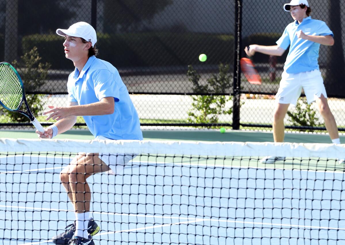 CdM's No. 1 doubles team of Jonathan Hinkel, left, and Roger Geng competes against University on Friday.