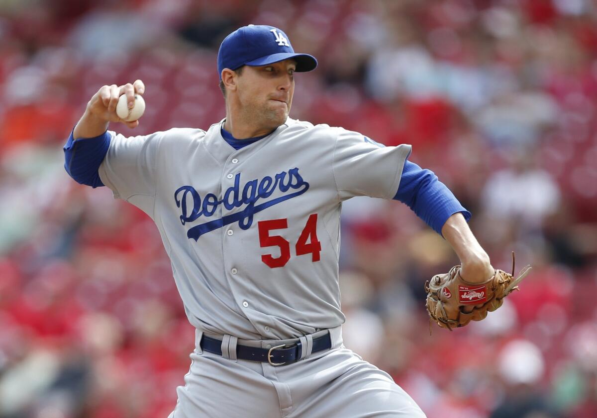 Jim Johnson, who was acquired before the non-waiver trade deadline from the Braves, delivers a pitch against the Reds during a game on Aug. 27 in Cincinnati.