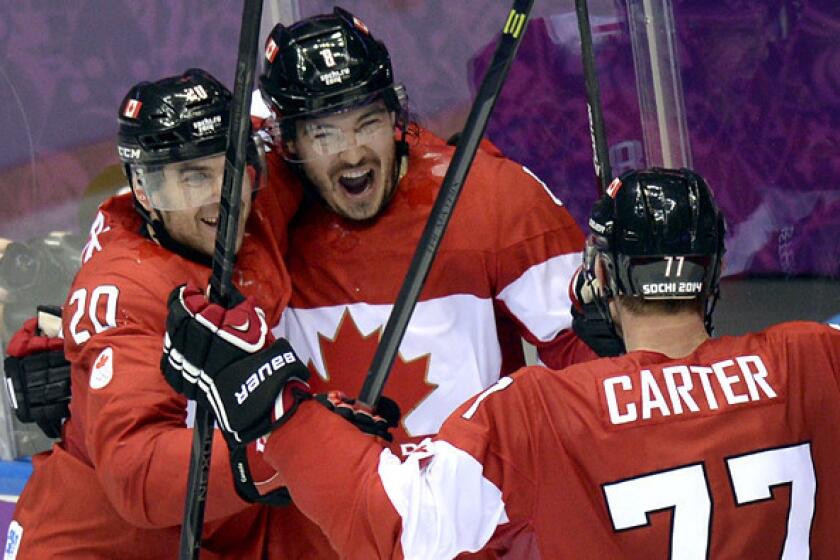 Canada defenseman Drew Doughty celebrates with teammates after scoring the winning goal in overtime against Finland on Sunday in a preliminary-round game at the Sochi Olympics.