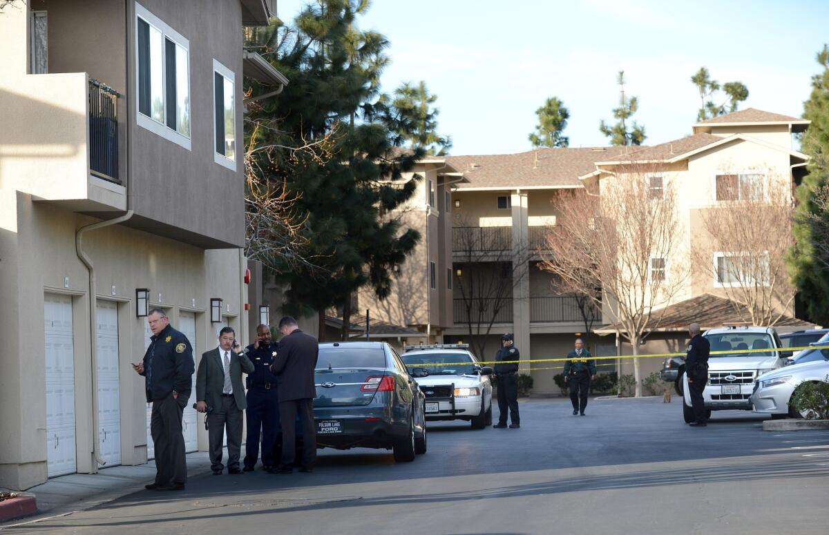 Law enforcement officers investigate the accidental fatal shooting Tuesday of a Bay Area Rapid Transit police officer by a fellow BART officer during a search at an apartment building.