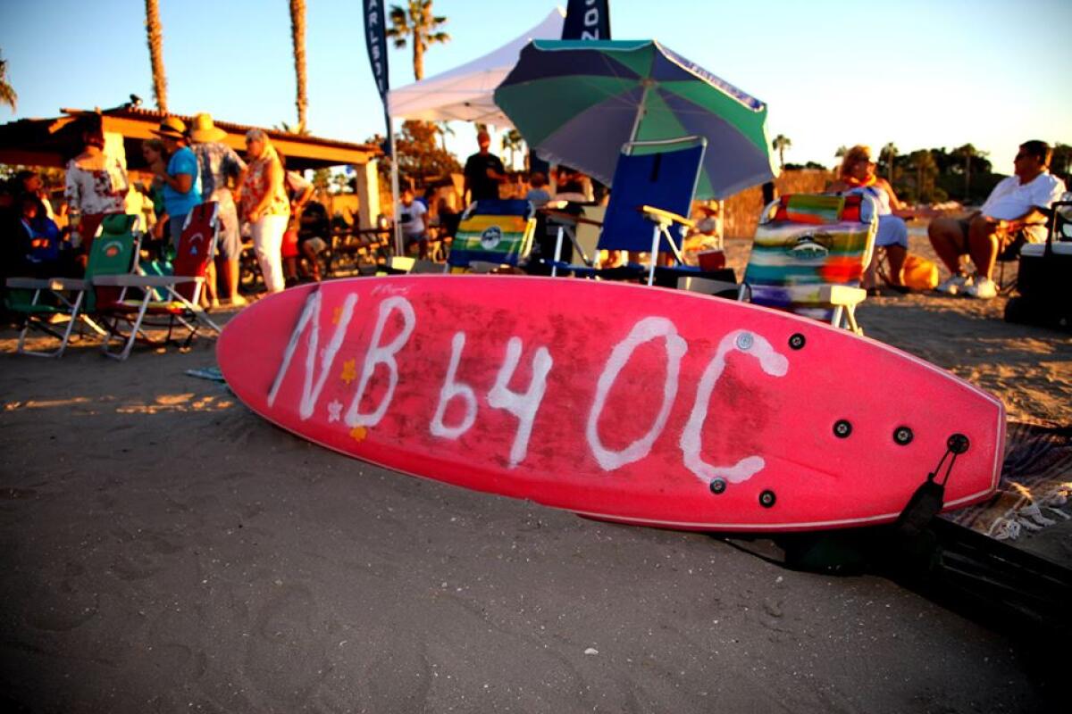 A surfboard reads "N.B. b4 O.C." at the Ben Carlson Foundation benefit party that the Facebook group held in 2015.