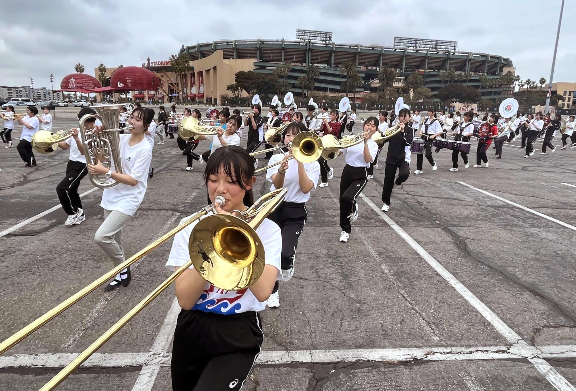 A band rehearsing in a parking lot.