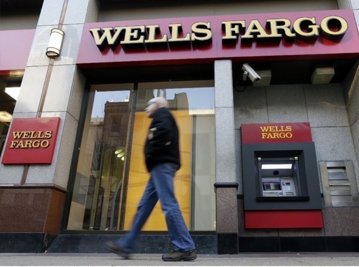 A man walks past a Wells Fargo location in Philadelphia.
