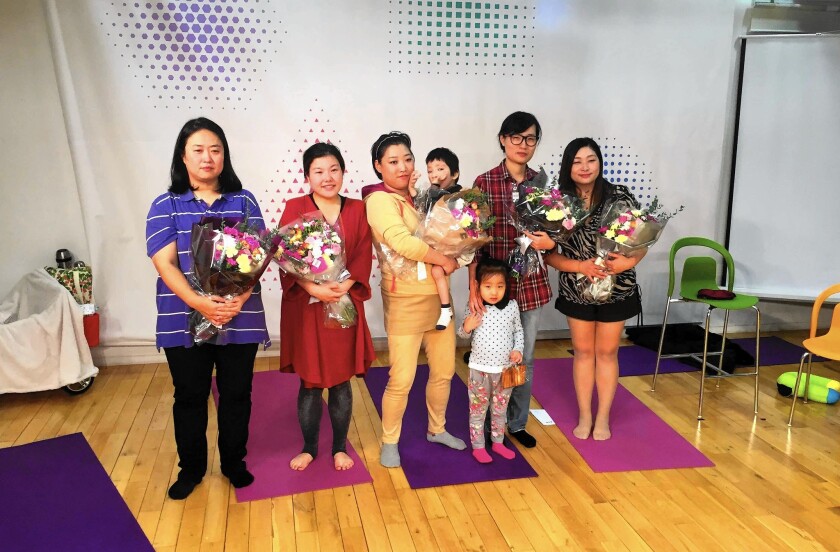 Lee Yeon-ji, second from right, and four other single mothers gather with their children after performing "Special Stories From Normal Women." They wrote the play to illustrate their struggles and their anguished decisions to raise a child on their own.