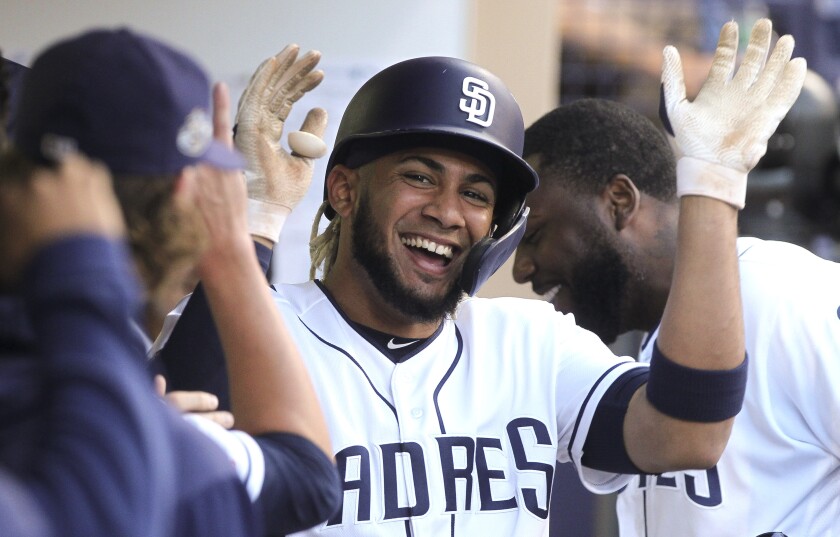 The Padres' Fernando Tatis Jr. celebrates his home run with teammates in the dugout during the fourth inning against the Giants at Petco Park on Wednesday, July 3, 2019 in San Diego, California.