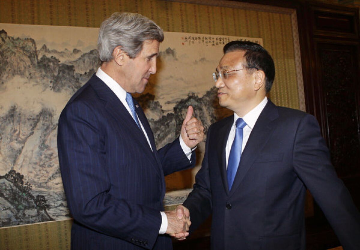 Secretary of State John Kerry, left, shakes hands with China's Premier Li Keqiang during a meeting in Beijing.