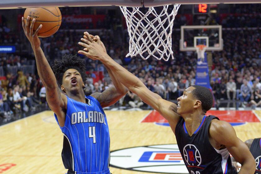 Clippers' Wesley Johnson, right, defends Orlando's Elfrid Payton during Saturday's game.