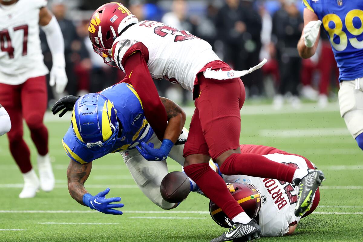 Rams running back Kyren Williams (23) fumbles against the Commanders.