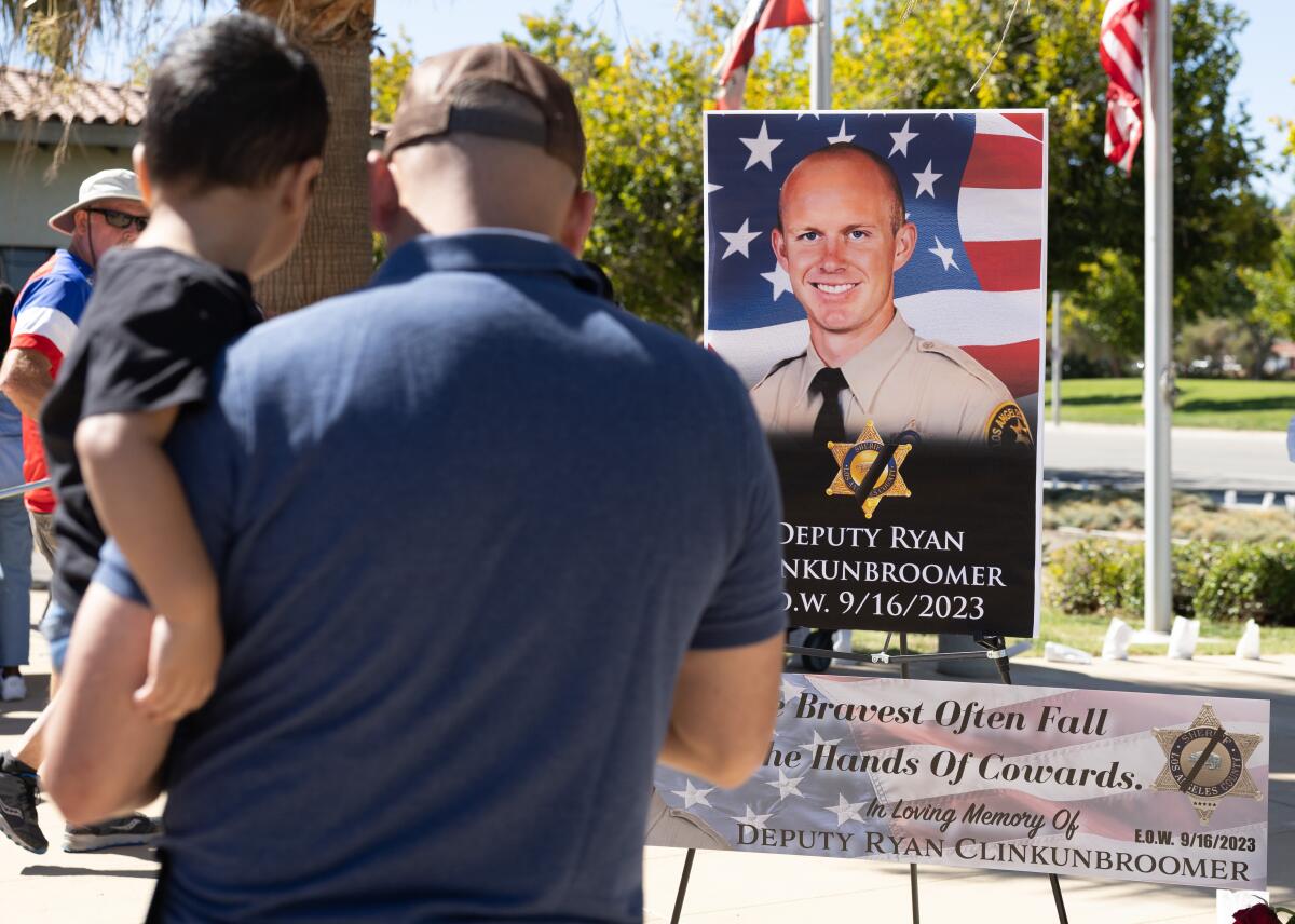 A memorial for Los Angeles County Deputy Ryan Clinkunbroomer stands at the Palmdale sheriff's station.