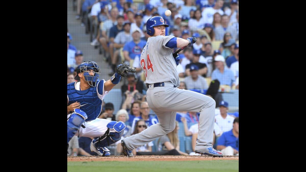 Cubs pitcher Jon Lester gets a high-inside pitch from Dodgers pitcher Rich Hill in the third inning.