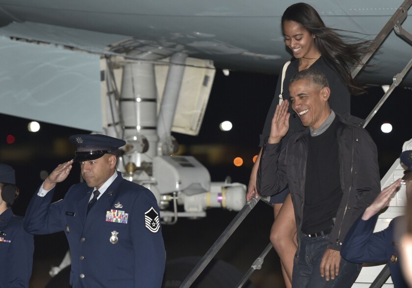 President Obama and older daughter Malia step off Air Force One last month outside Washington.